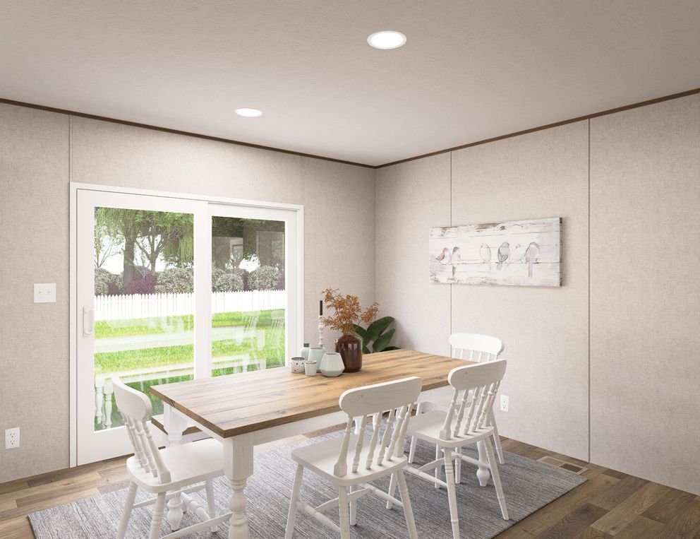 Bright dining room with wooden table, white chairs, large window, and wall art on beige walls.