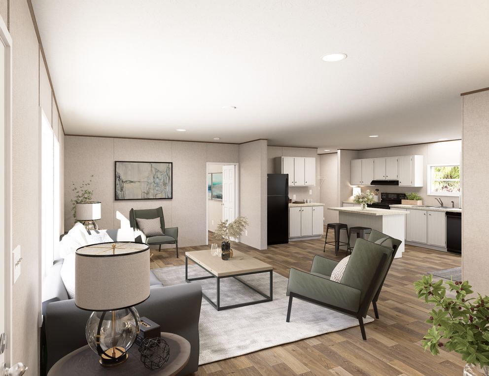 Modern open-plan living room and kitchen with gray furniture, light wood floors, and large windows