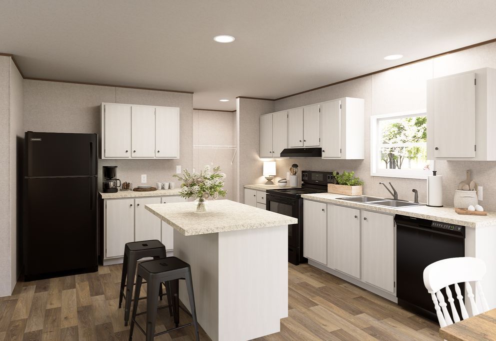 Modern white kitchen with black appliances, central island, and stools under bright ceiling lights