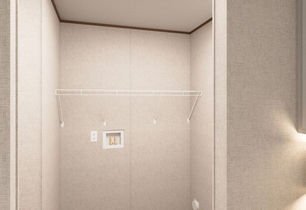 Minimal beige room with a wall-mounted shelf and outlet, viewed in soft lighting.