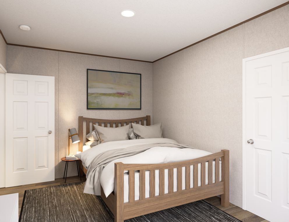 A cozy bedroom with a wooden bed, neutral walls, white doors, and framed wall art.