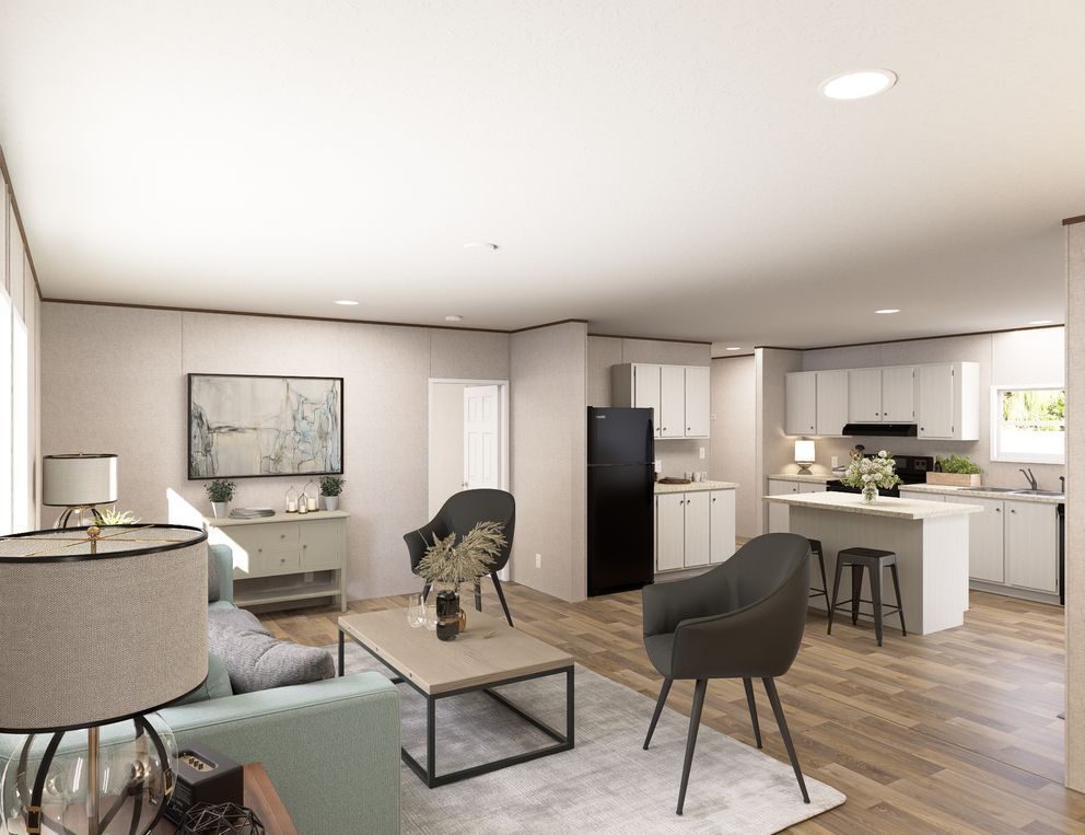Open-plan modern living room and kitchen with light wood floors and neutral furniture