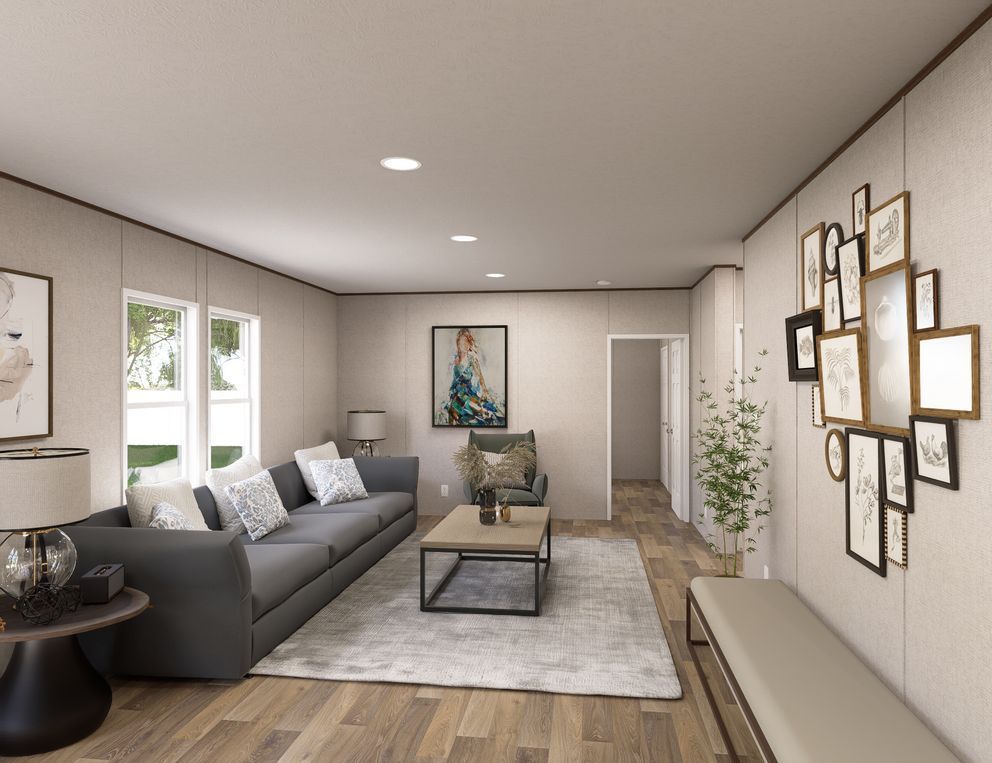 Modern living room with gray sofa, coffee table, wall art, and soft neutral decor.