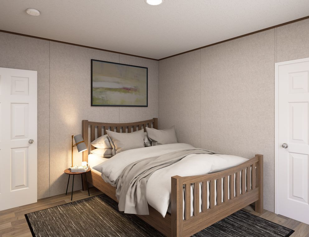 Cozy bedroom with a wooden bed, bedside lamp, framed art, and two white doors on beige walls.