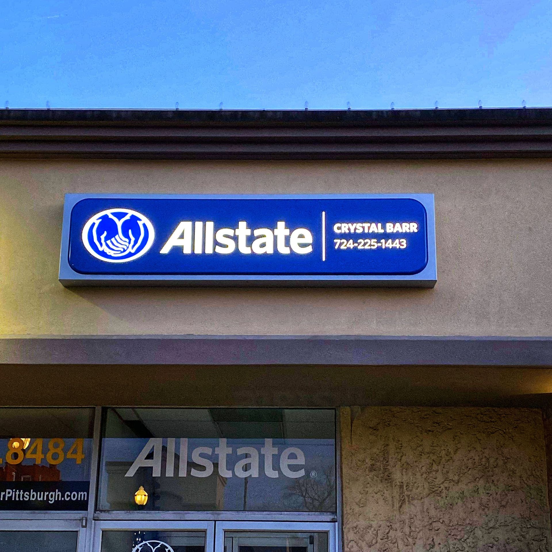 Allstate sign with the Crystal Bank phone number on a building exterior.