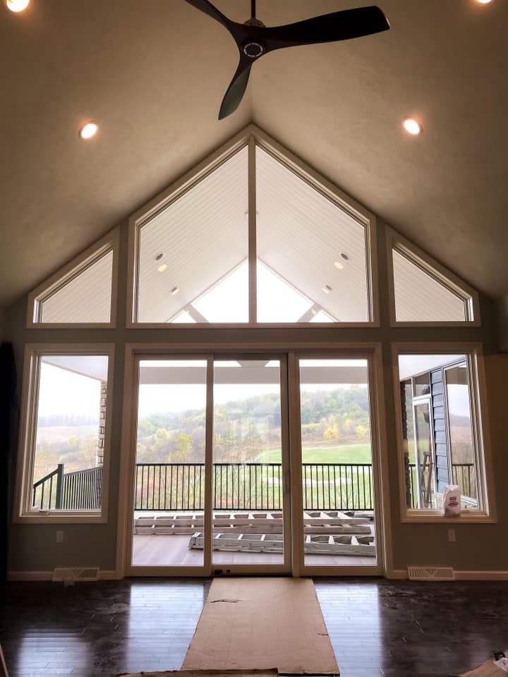 Interior of a home with large windows and a view of a deck and landscape.