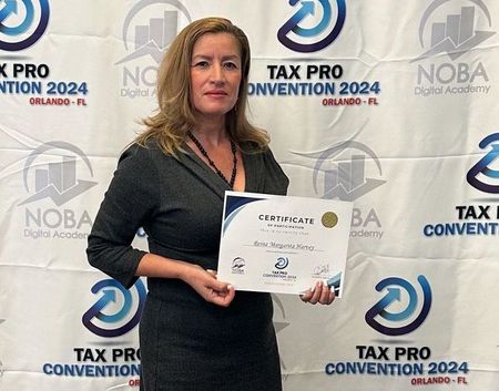 A woman is holding a certificate in front of a wall