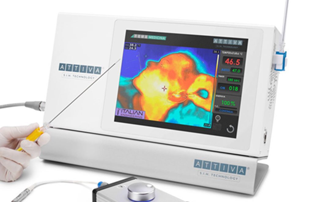 Medical device displaying thermal imaging of tissue; a hand holds a probe.