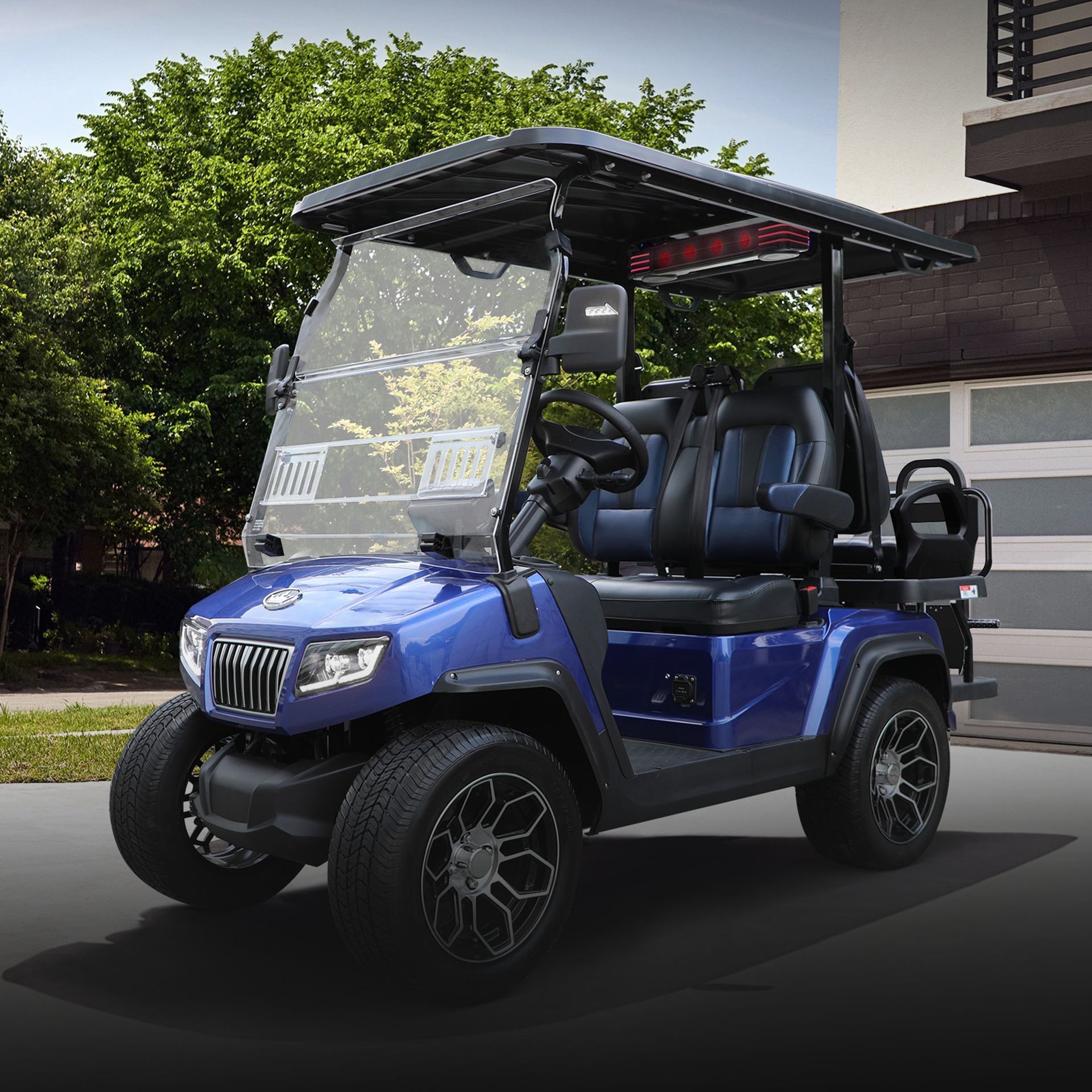 A blue golf cart is parked in front of a garage door