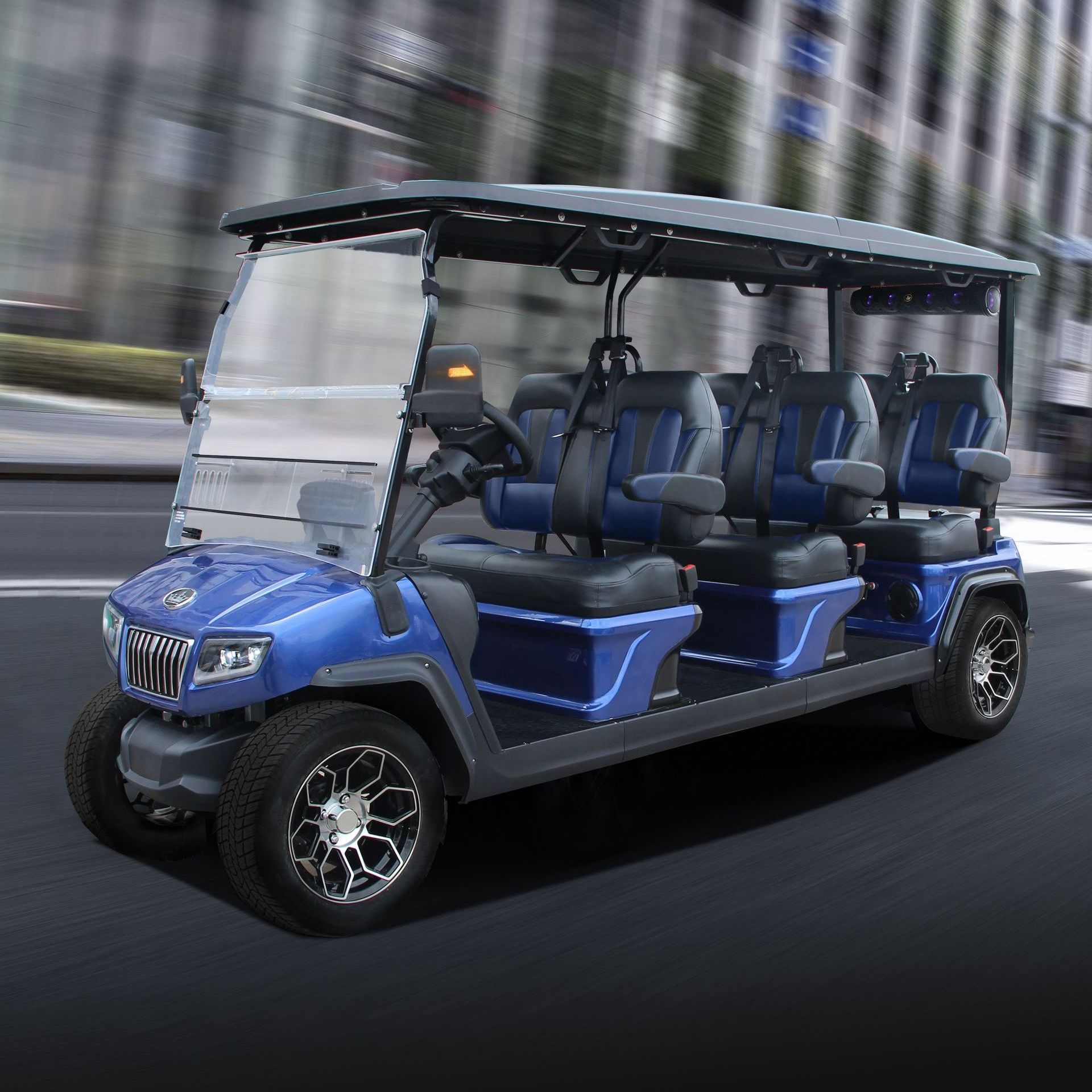 A blue golf cart is driving down a city street