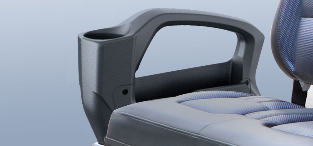 A close up of a chair with a cup holder on the arm rest.
