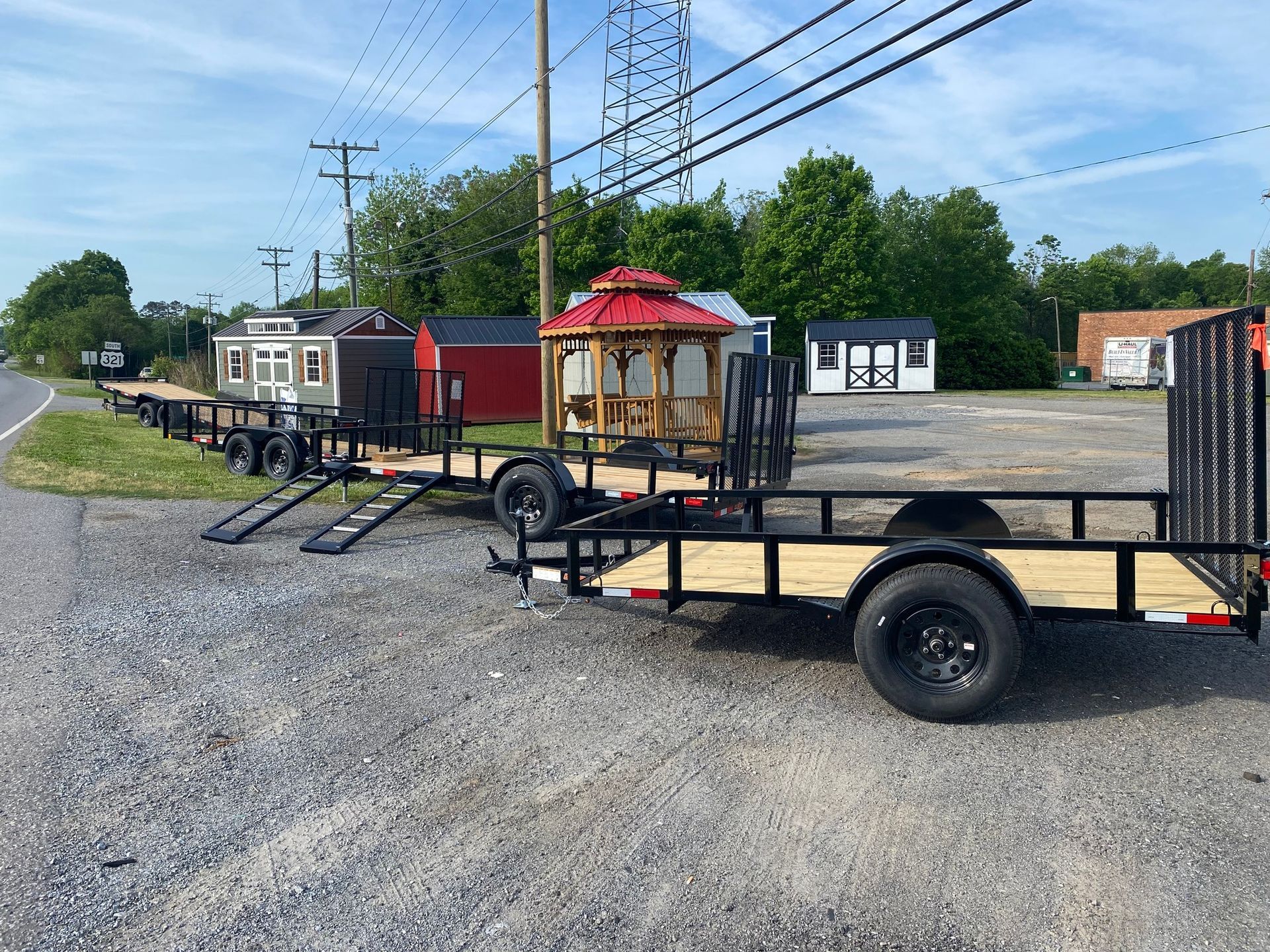 A row of trailers is parked on the side of the road.