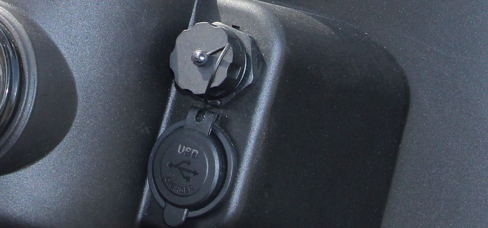 The trunk of a golf cart is open and empty