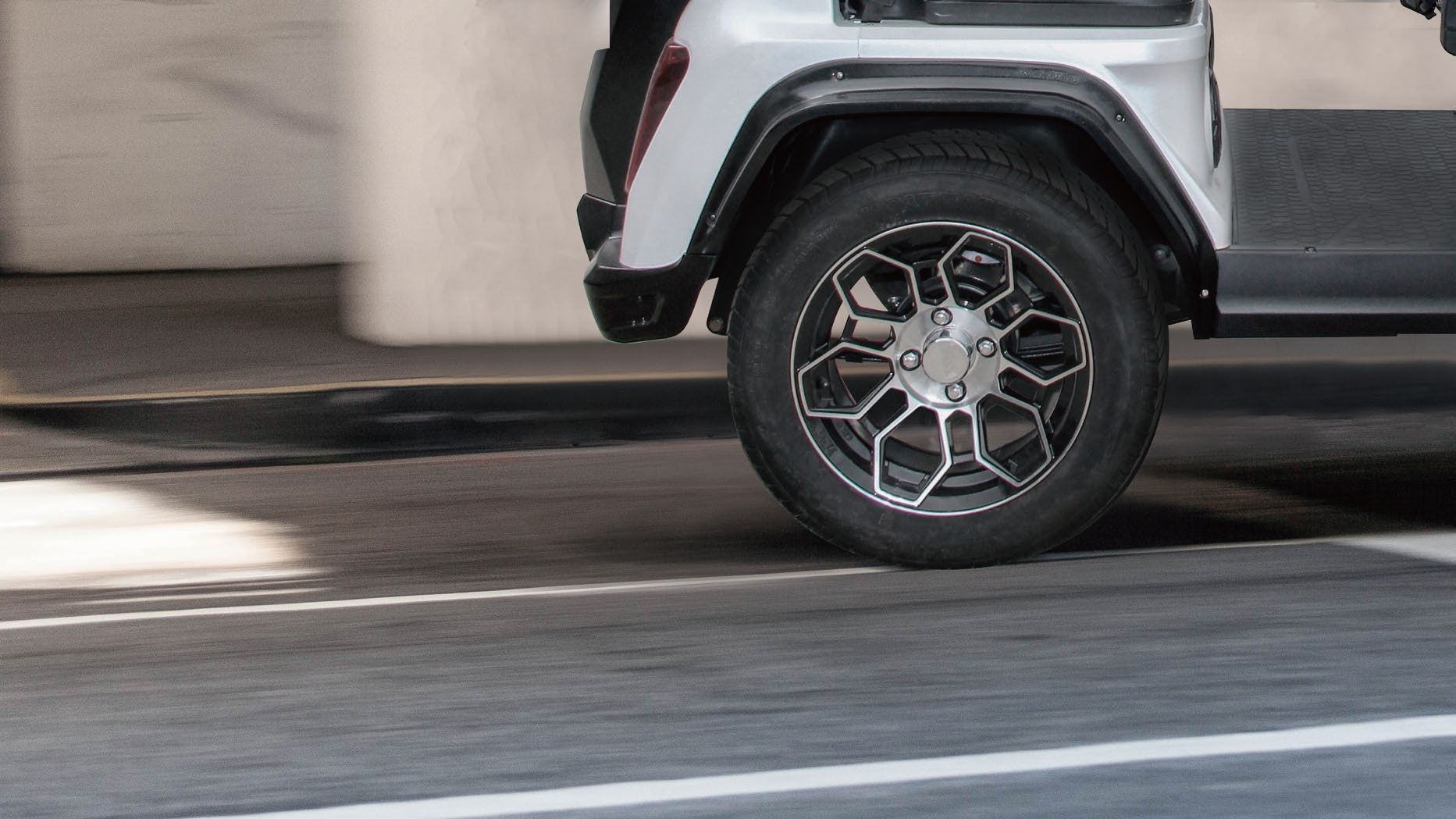 A close up of a car 's wheel on a street