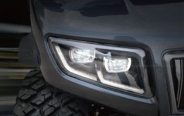 A close up of a golf cart 's headlight.