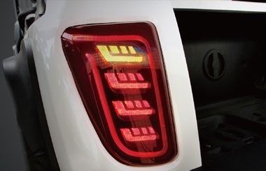 A close up of a white truck 's tail light.