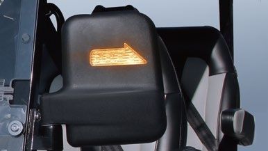 A close up of a side view mirror with an arrow pointing to the right