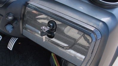 A close up of a golf cart dashboard with a key in it.