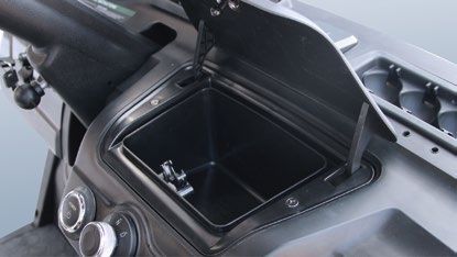 The dashboard of a golf cart with the lid open.
