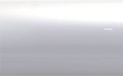 A close up of a white surface with a reflection of a light.