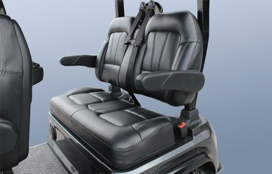 The back seat of a golf cart has a seat belt on it