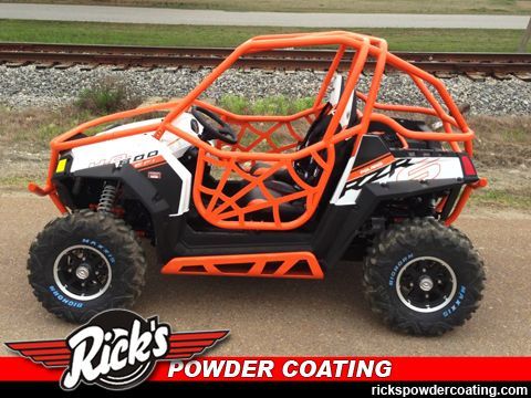 Orange roll cage on black-and-white off-road side-by-side with “Rick’s Powder Coating” logo