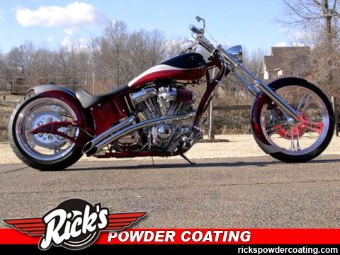 Custom red chopper motorcycle parked outdoors with Rick’s Powder Coating logo