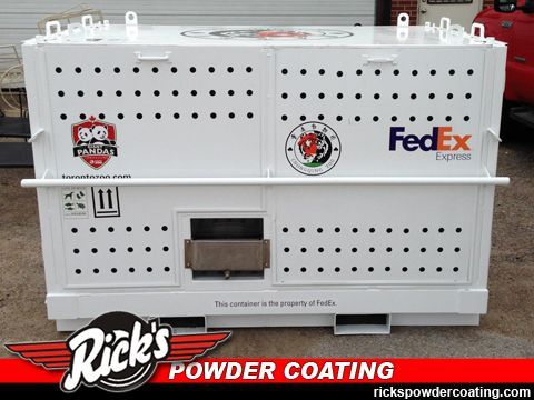 White perforated pet crate with stickers and FedEx logo, shown on a Rick’s Powder Coating background
