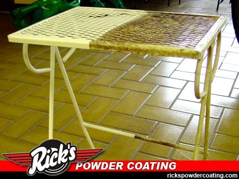 Yellow metal table before and after powder coating, shown half white and half rusted brown on tiled floor
