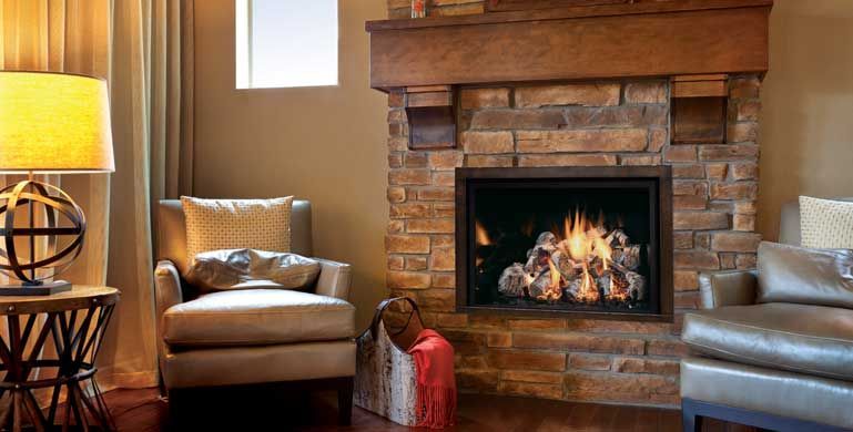 Fireplace with stone surround and wooden mantel in a cozy living room setting; lit fireplace.