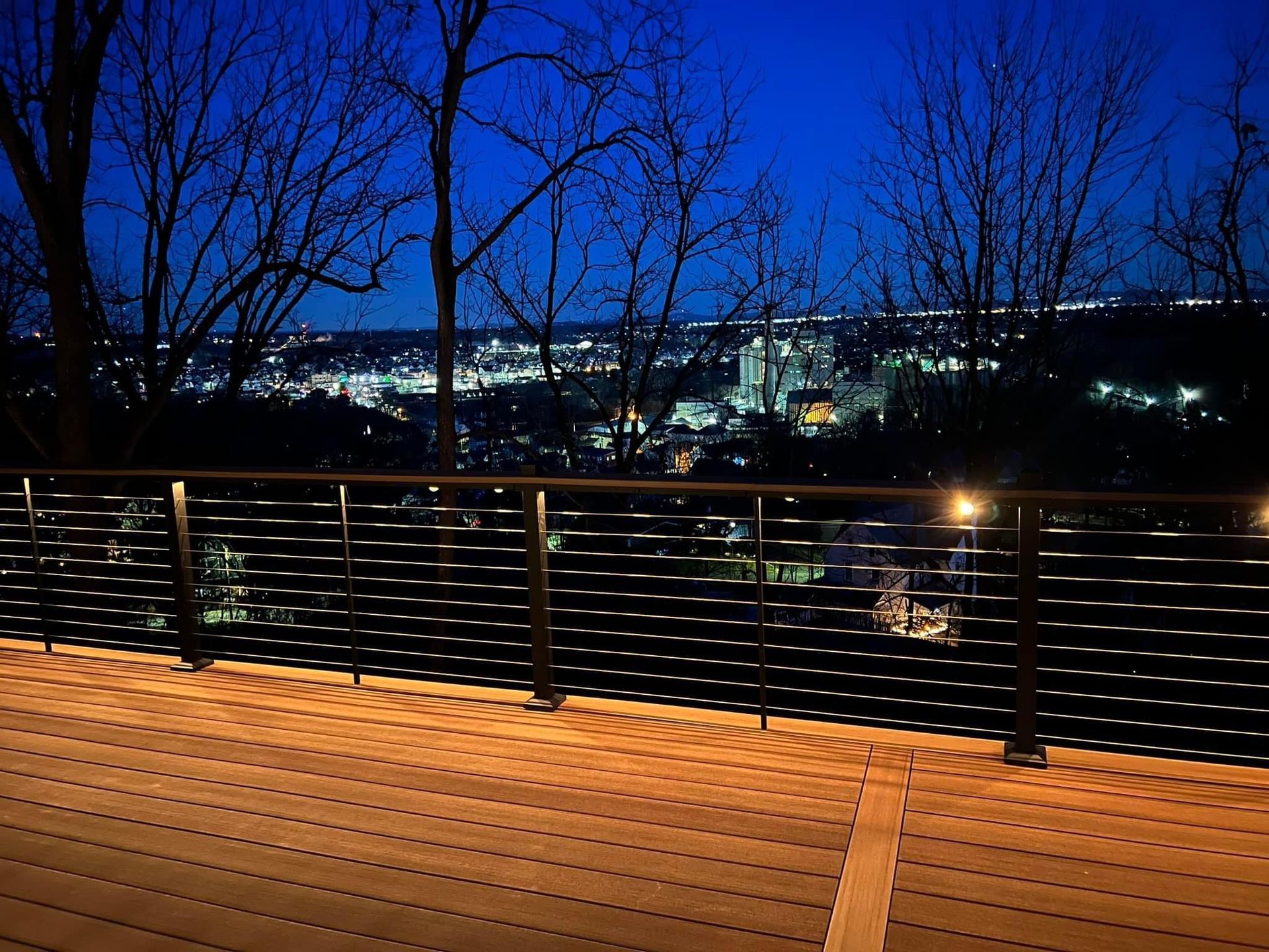 A deck with a view of a city at night