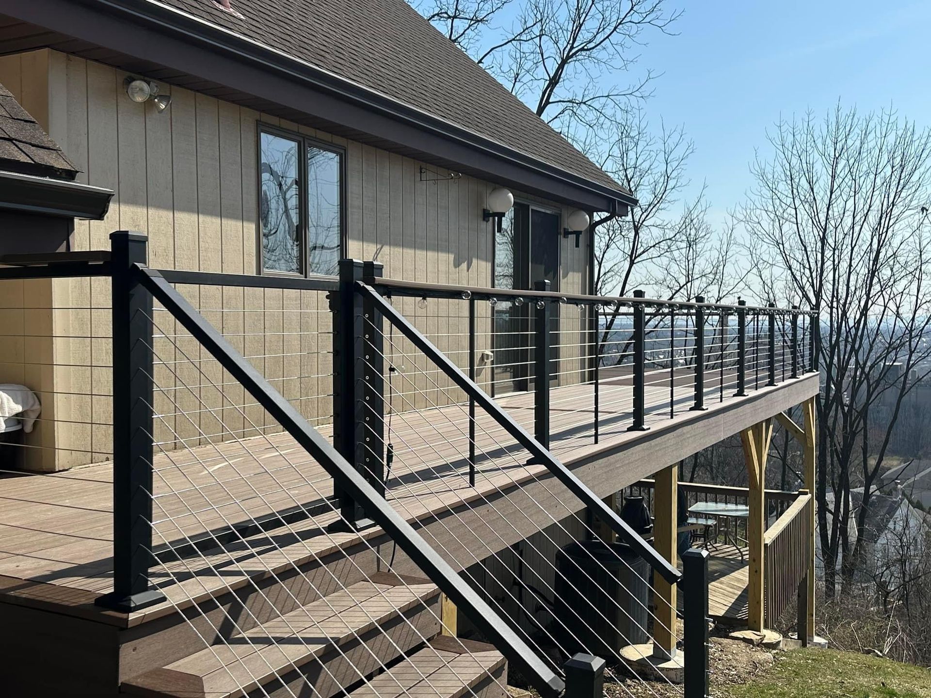 A house with a large deck and stairs leading up to it.