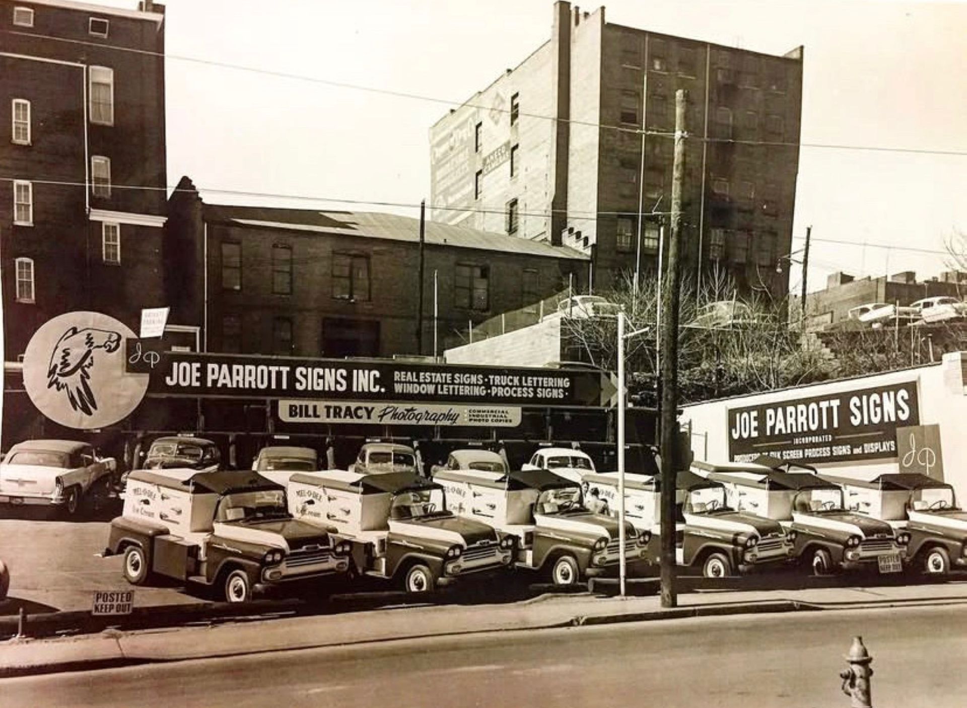 Joe Parrott Signs Inc. storefront with trucks parked out front.