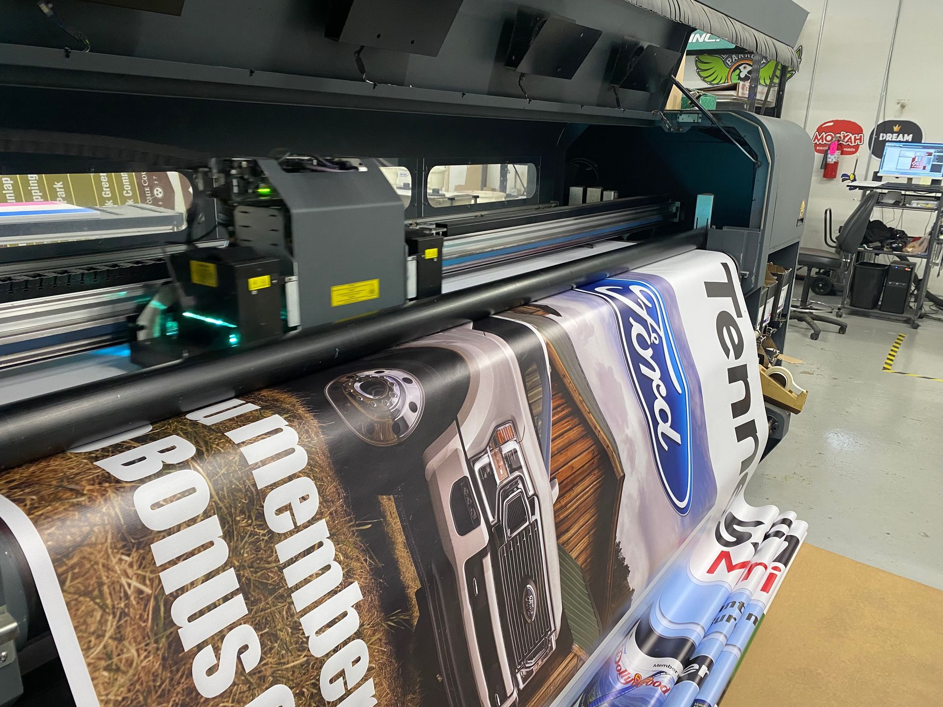 Large format printer printing a Ford advertisement on a banner.