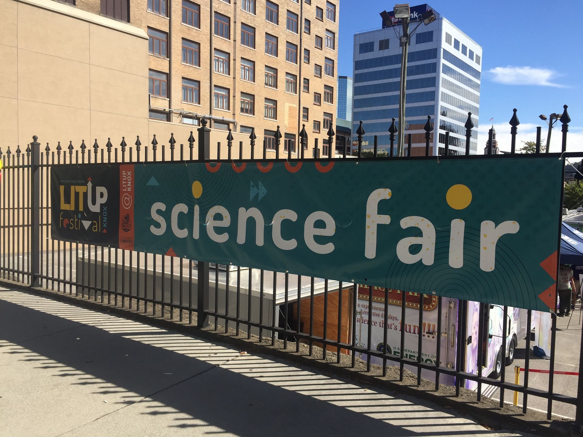 Banner on a fence reads