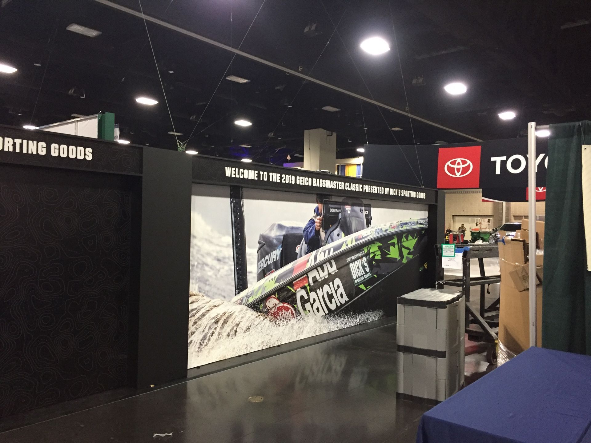 Boat display at a trade show with the Toyota logo in the background.