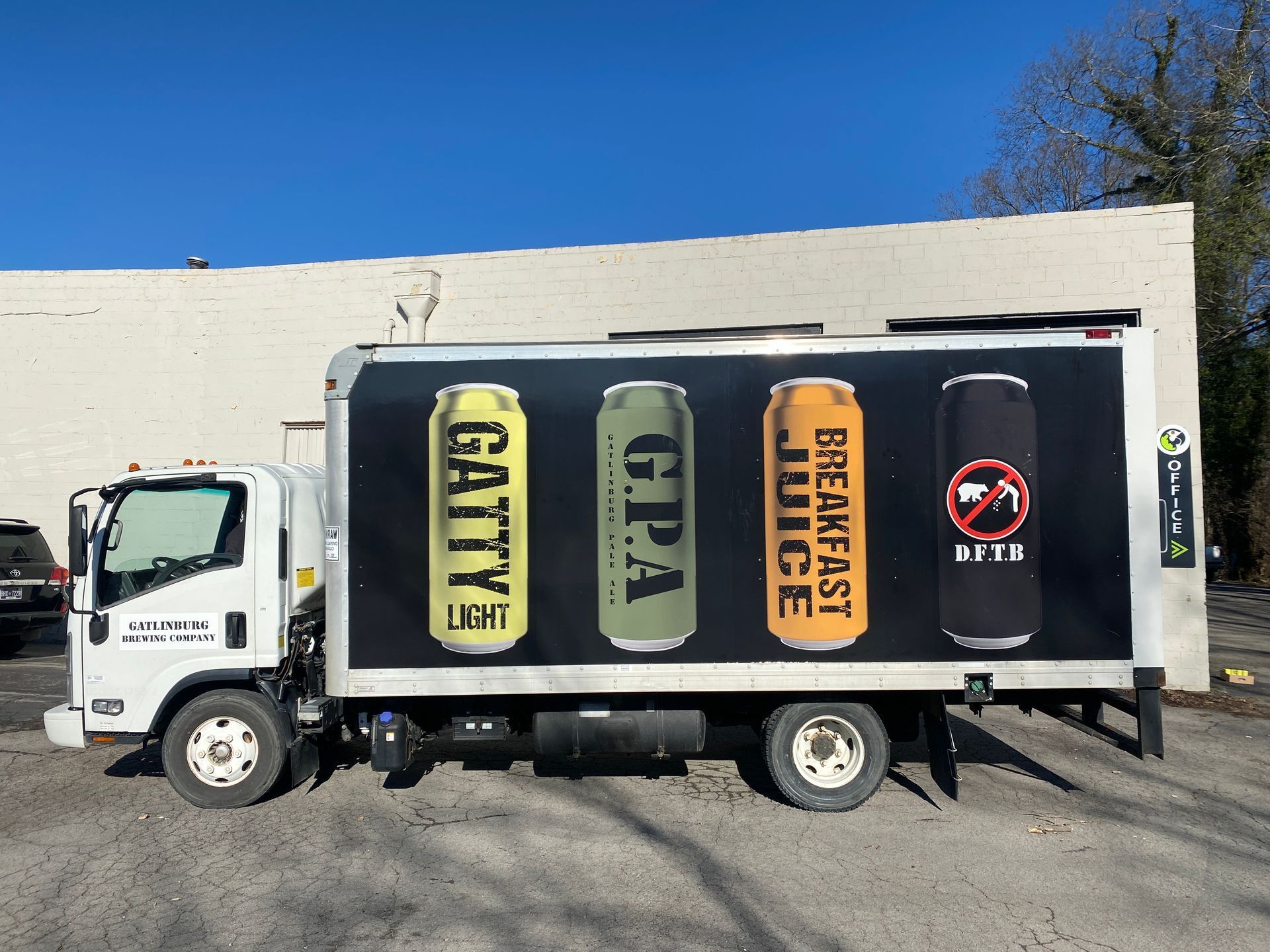 White truck with four beer can designs: