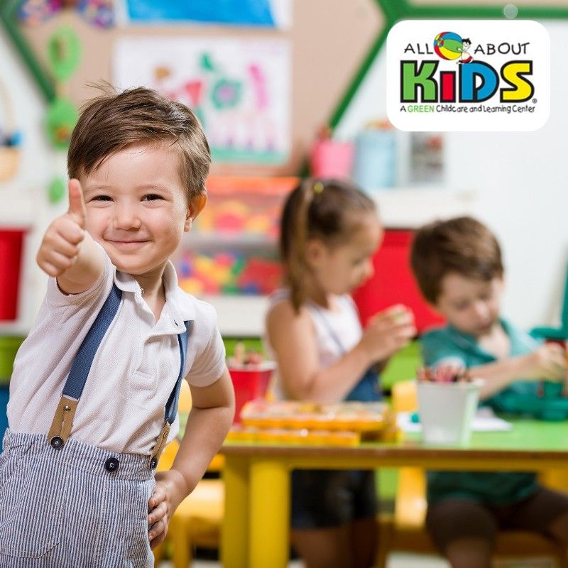 A group of children are petting a hedgehog in a classroom.