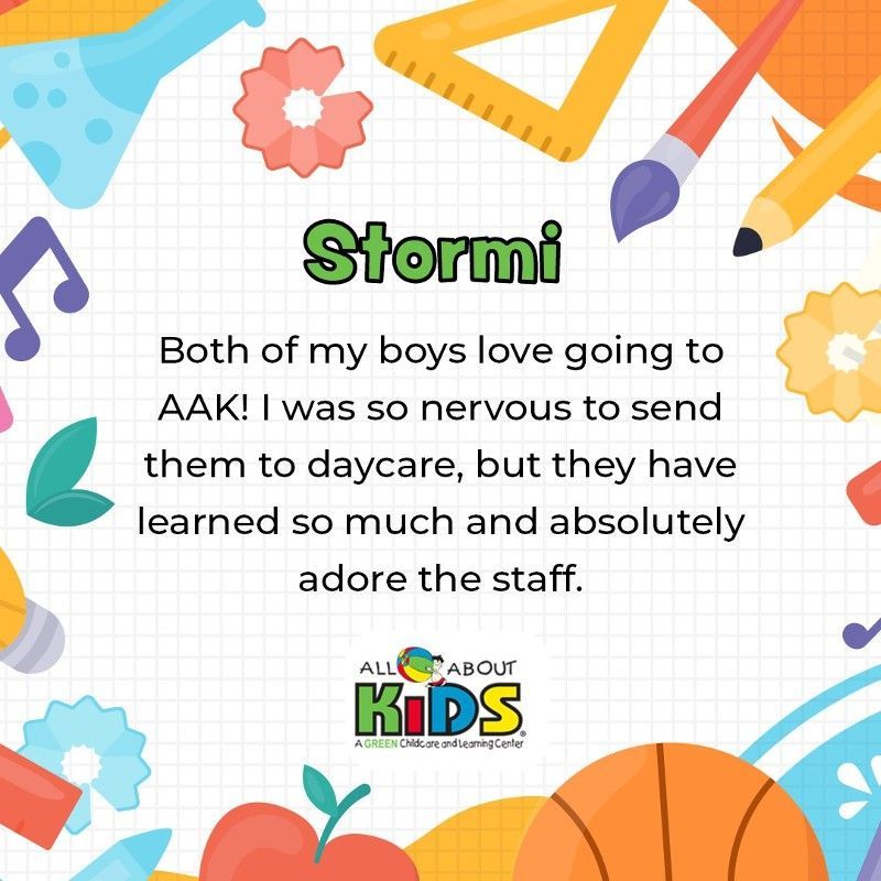 A young boy is giving a thumbs up in front of a sign that says all about kids