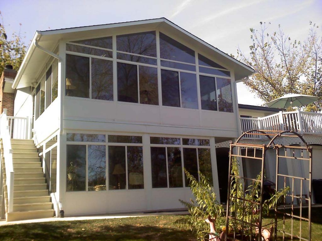 A white house with a lot of windows and stairs