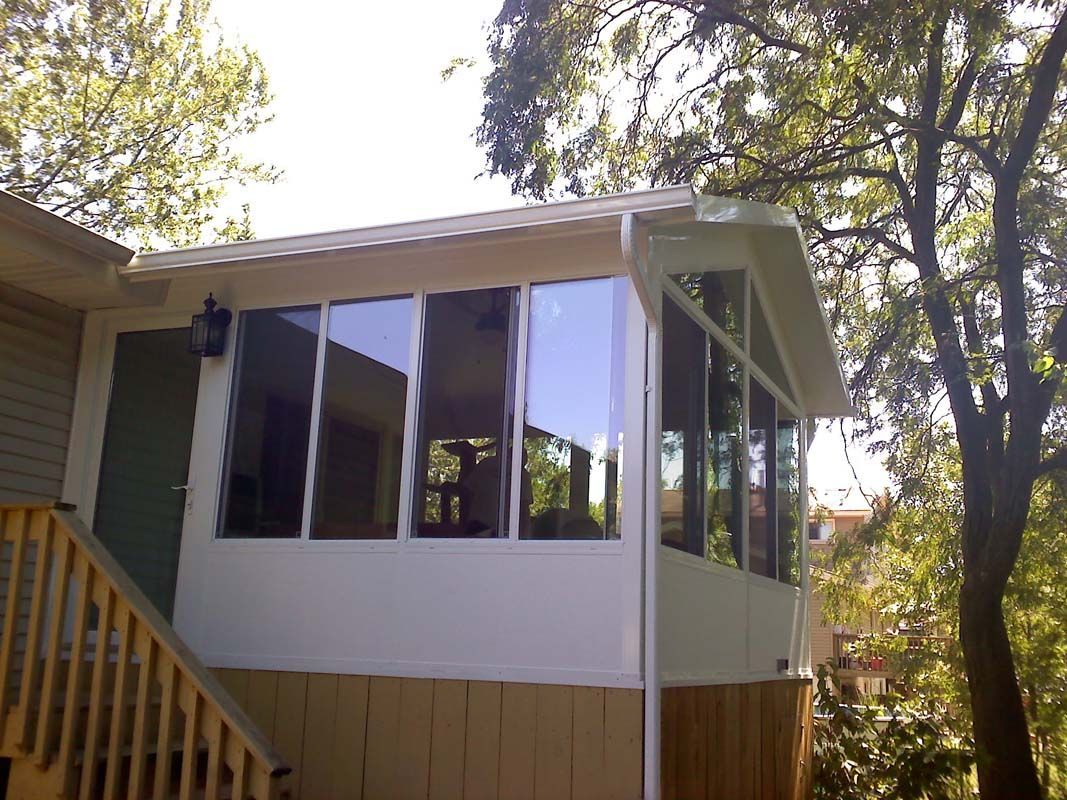 A house with a screened in porch and stairs