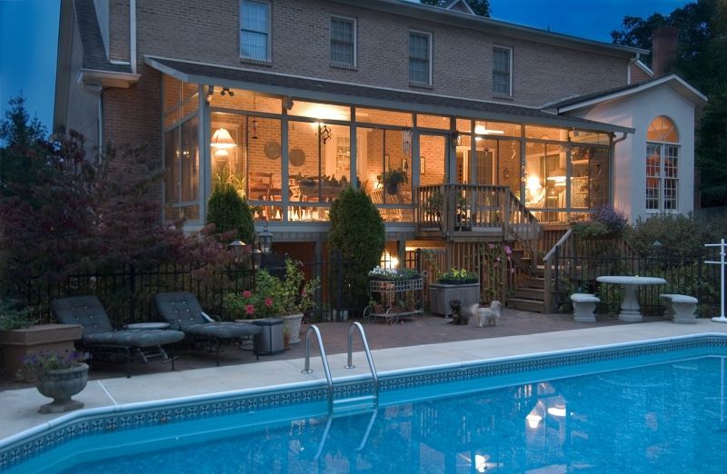 A large house with a swimming pool in front of it