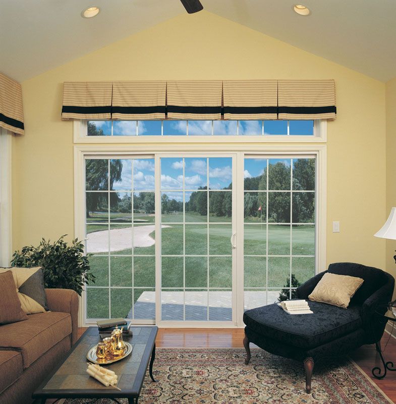 A living room with sliding glass doors leading to a golf course