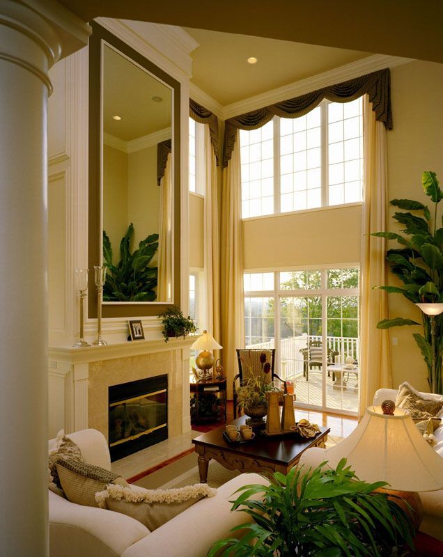A living room with a fireplace and a large mirror