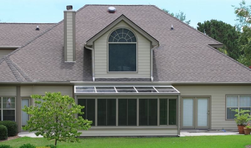 A house with a screened in porch and a large window