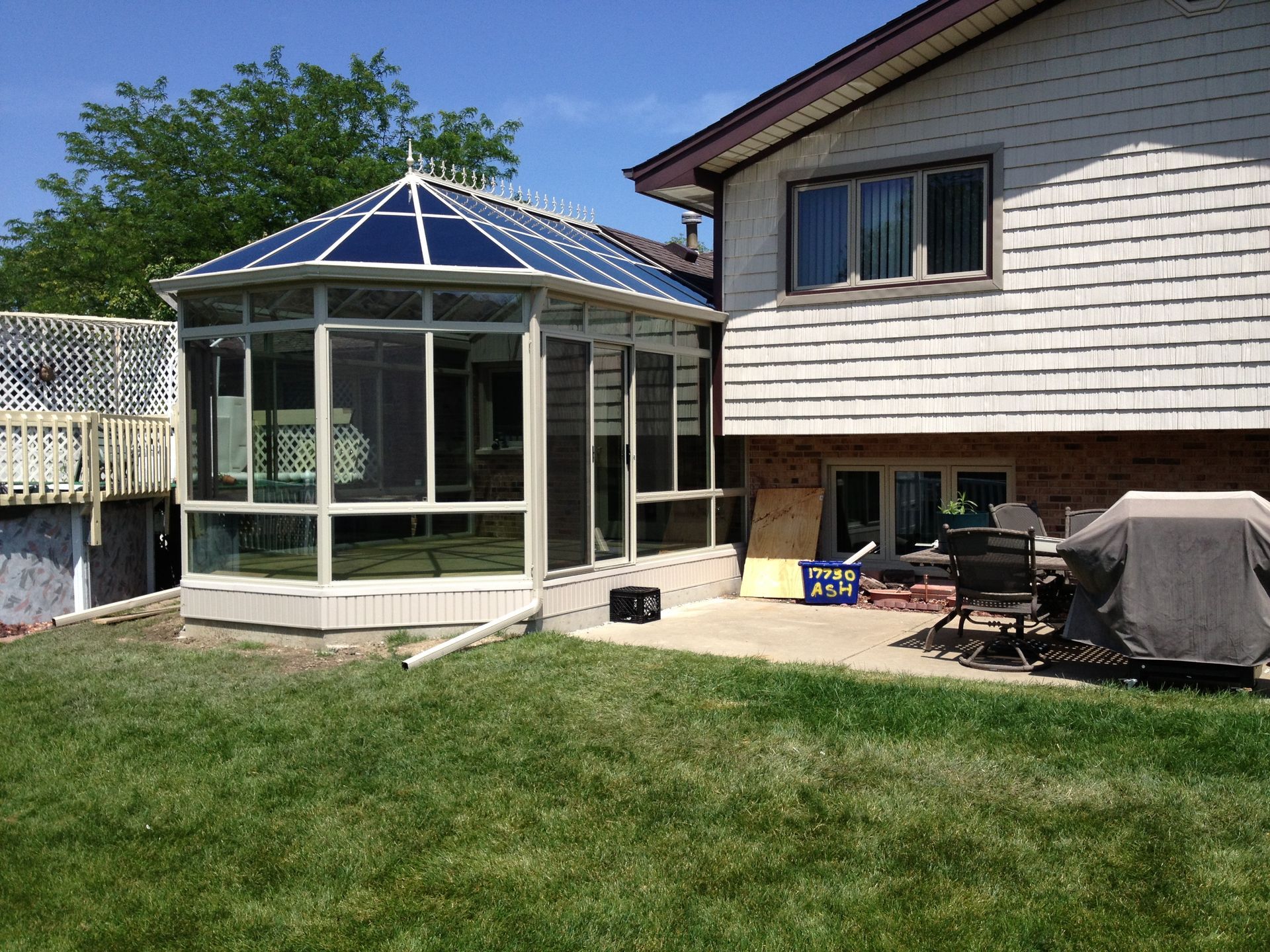 There is a gazebo in the backyard of a house.
