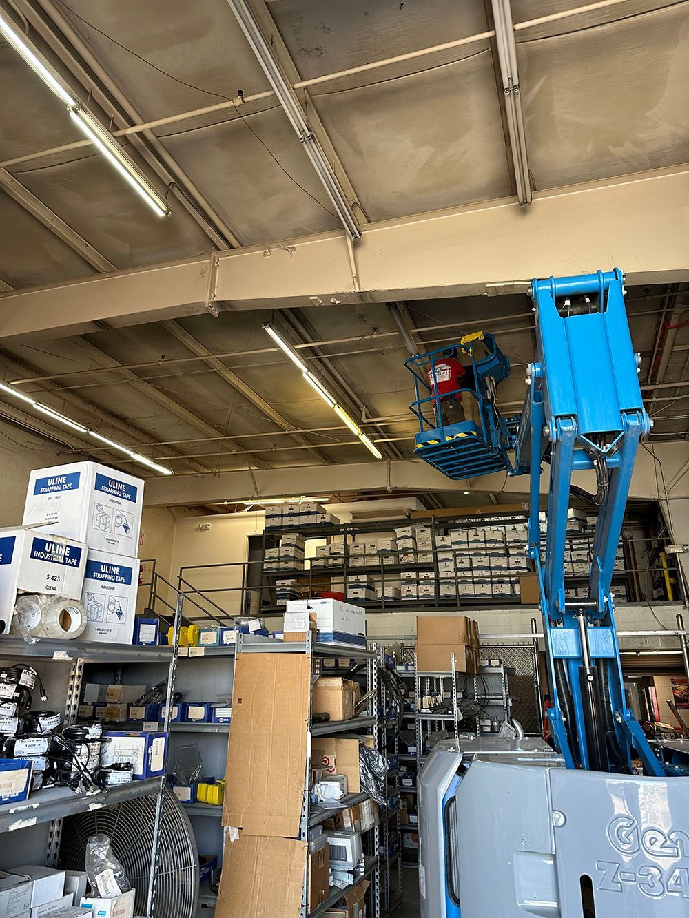 A man is sitting on a lift in a store.