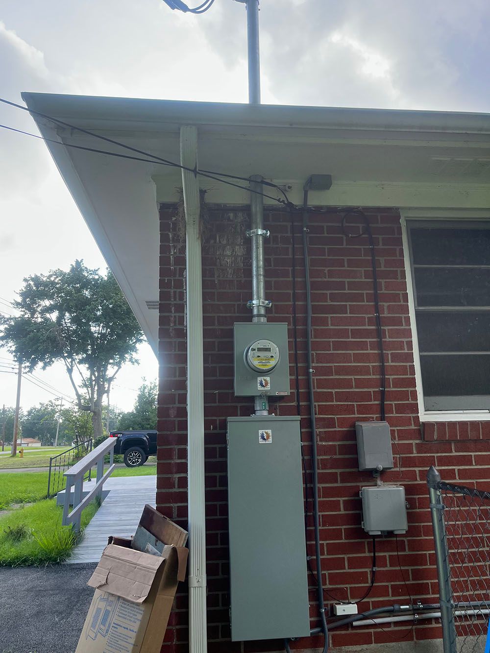 A brick house with a meter on the side of it.