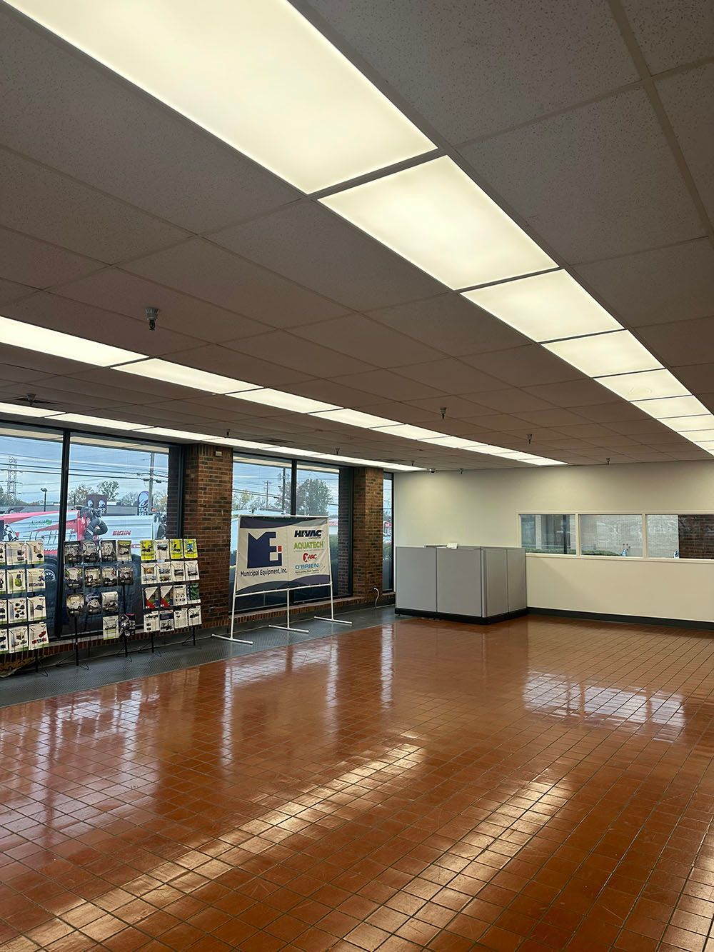A large room with a wooden floor and a lot of lights on the ceiling.