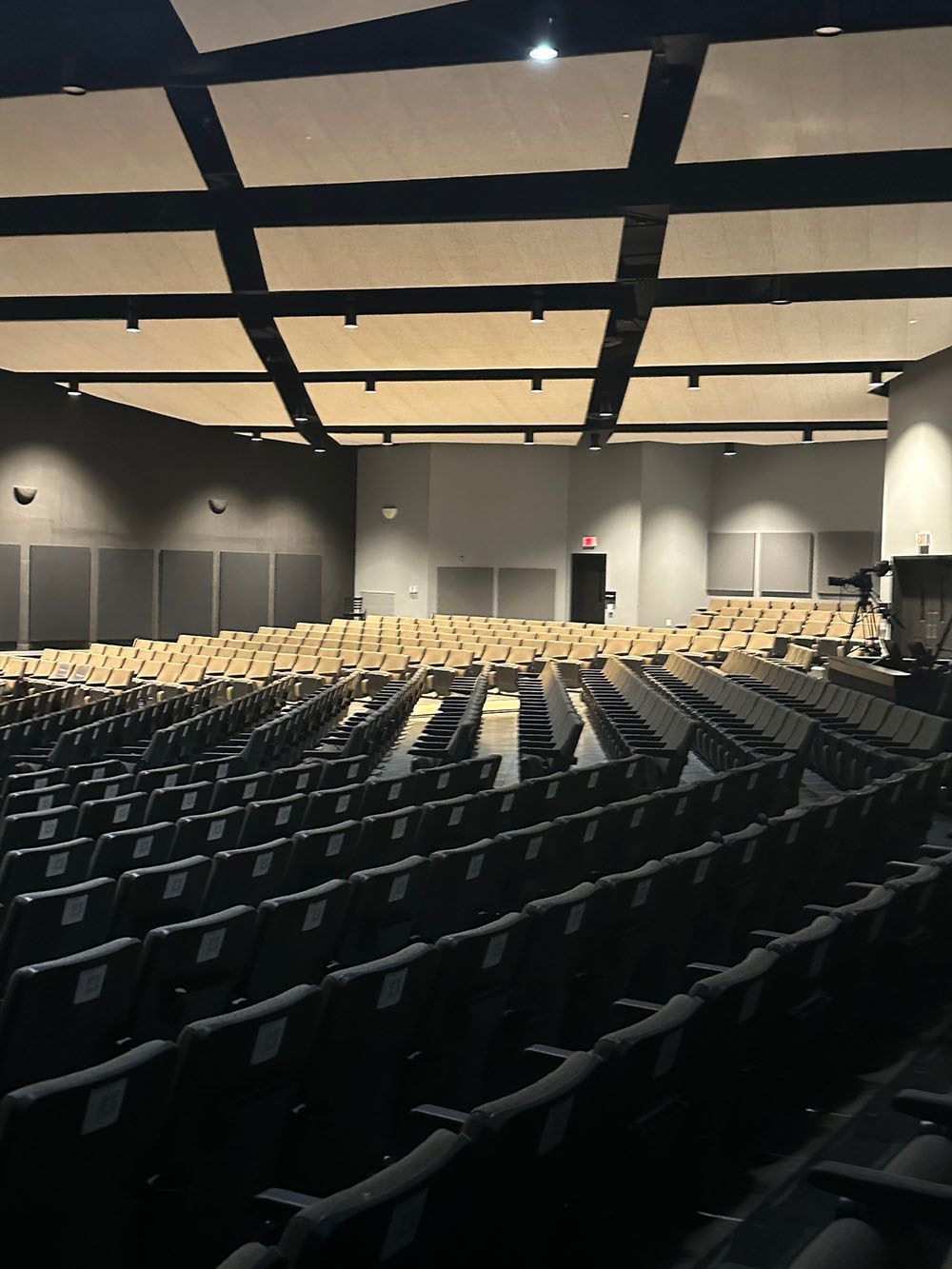A large auditorium filled with rows of empty seats.